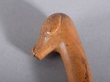 a close up of a wooden walking stick with a horse head on it