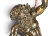a bronze statue of a man holding an umbrella