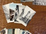 a lot of old black and white photos on the table