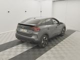 the rear end of a grey car parked in a garage