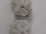 two balls of cotton on a white surface covered in snow