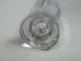 a glass with a liquid inside of it sitting on a table