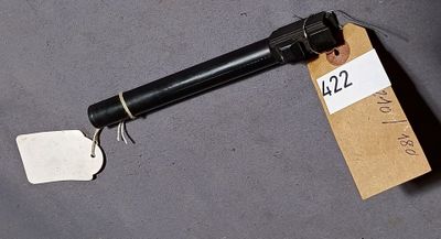 a gun with a tag attached to it sitting on a table