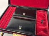 a black briefcase with red linings sitting on a white surface