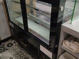 a glass display case in the middle of a store