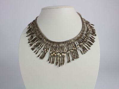 a close up of a necklace on a mannequin mannequin