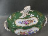 a green bowl with flowers and a bird on it