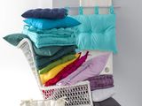 a chair that has many pillows in it