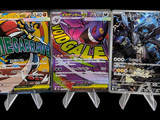 a lot of pokemon cards on display on a black background