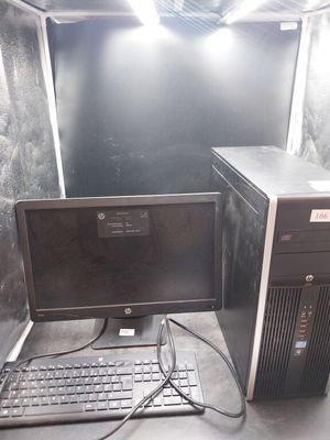 un ordinateur de bureau posé à côté d'un clavier et d'un écran