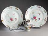 two plates and a cup sitting on a table