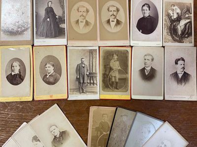 many old photographs of men and women sitting on a table