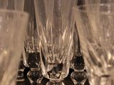 many empty wine glasses lined up on a table