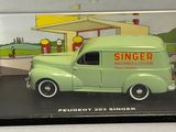 a green toy truck in a glass case