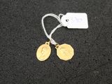 a close up of a pair of earrings with a tag on them