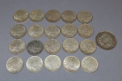 several different coins are arranged in a triangle on a table