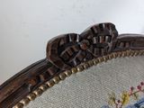 a close up of a wooden frame with a flower on it