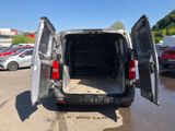 the back of a van with its doors open in a parking lot