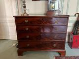 a dresser with a clock on top of it in a room