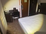 a bed and a desk in a small room