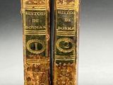 two old books that are sitting on a table