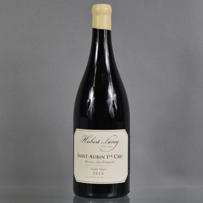 a bottle of wine sitting on top of a glass table
