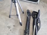 a camera and tripod sitting on the floor next to a case