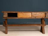 an old wooden table with two drawers on it