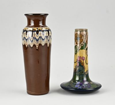 two vases sitting next to each other on a white surface