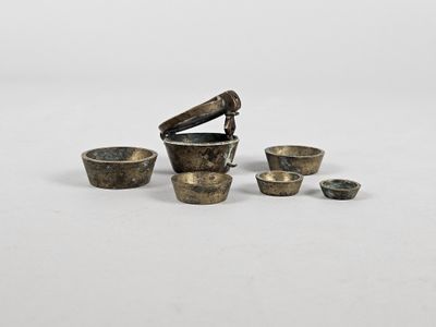 une image représentant un ensemble de petits objets métalliques posés sur une surface blanche