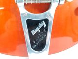 a close up of a guitar that is on display