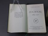 an open book on a table with a bookmark on top of it