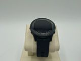 an image of a smart watch sitting on a stand on a white surface