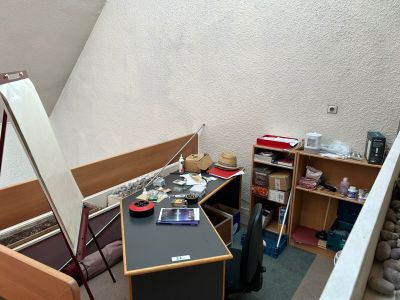 an image of a room with a desk and bookshelf