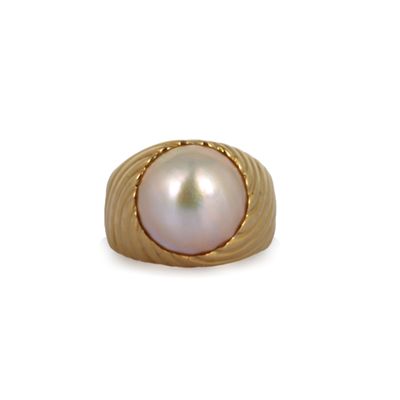 an image of a gold ring with a pearl in the center