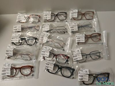 many pairs of glasses on the table with price tags on them