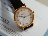 a watch sitting on top of a piece of paper