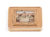 an old gold box with a picture of a building on it