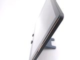 a tablet computer sitting on a stand on a white surface