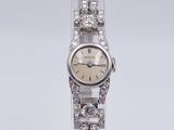 an image of a woman ' s wrist watch with diamonds on it