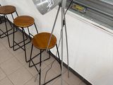 several stools are lined up against a wall in a room