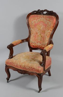 an old fashioned chair with a floral upholstered seat