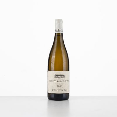 a bottle of white wine sitting on top of a table