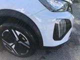 a close up of a white car with black rims