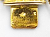 a gold plated necklace with a basket of flowers on it