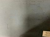 someone is writing on the wall of a bathroom with a toilet