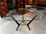 a glass table with a metal base and a glass top