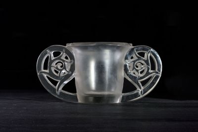 a glass cup that is sitting on a table