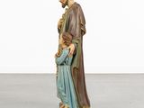a statue of jesus holding a child in his arms