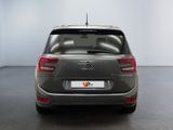 the rear of a grey citrole parked in a white room